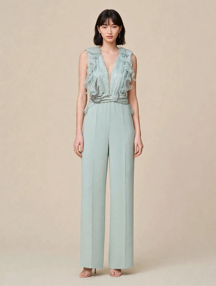 ANTONIO NOTARO - TUTA JUMPSUIT VERDE SALVIA IN CRÊPE CON CORPINO A V PROFONDO IN CHIFFON PLISSÉ CON VOLANT 3D E CINTURA GIOIELLO