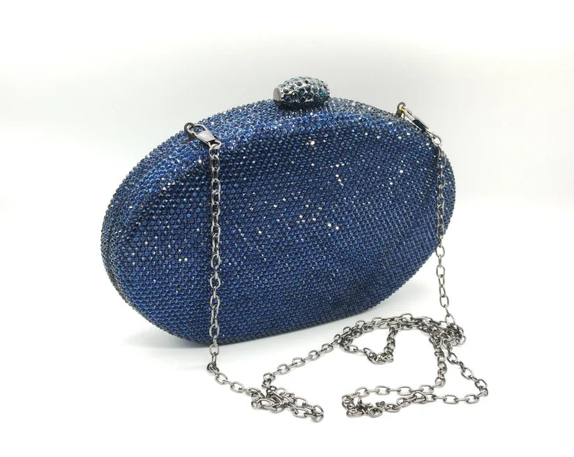 Borsetta da cerimonia rigida in strass color blu o rosa con tracolla interna removibile.