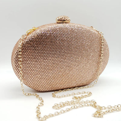 Borsetta da cerimonia rigida in strass color blu o rosa con tracolla interna removibile.