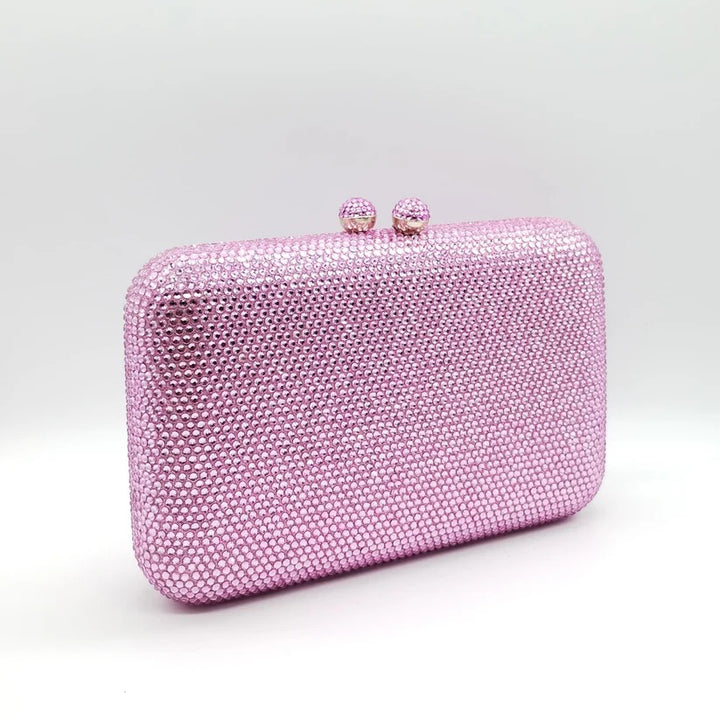 Borsetta da cerimonia rigida con strass color rosa e tracolla interna removibile.